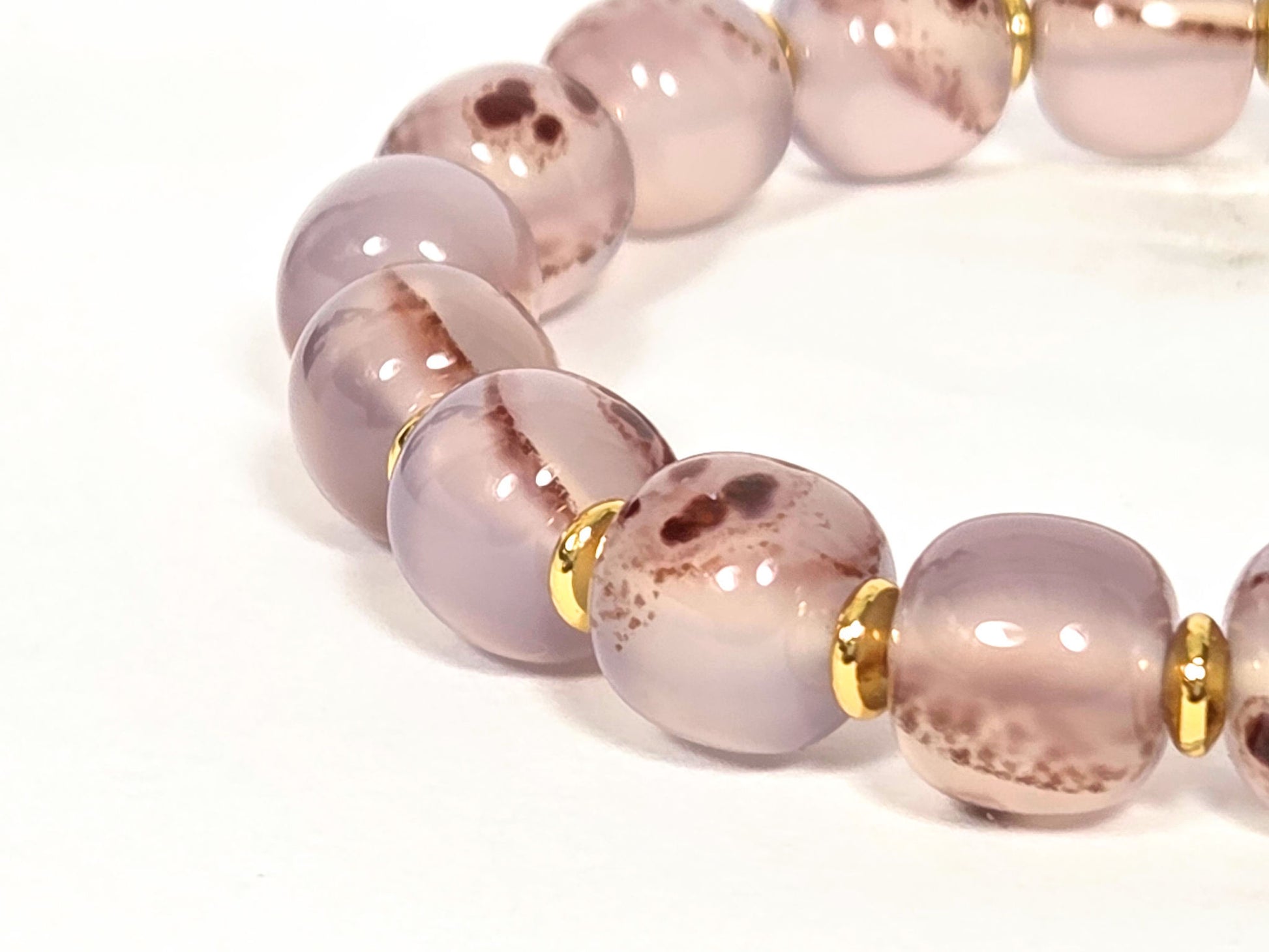 N-030526-CB2 side arc, semi-translucent mauve-rose beads, gold rondelle spacers, warm banding, unretouched