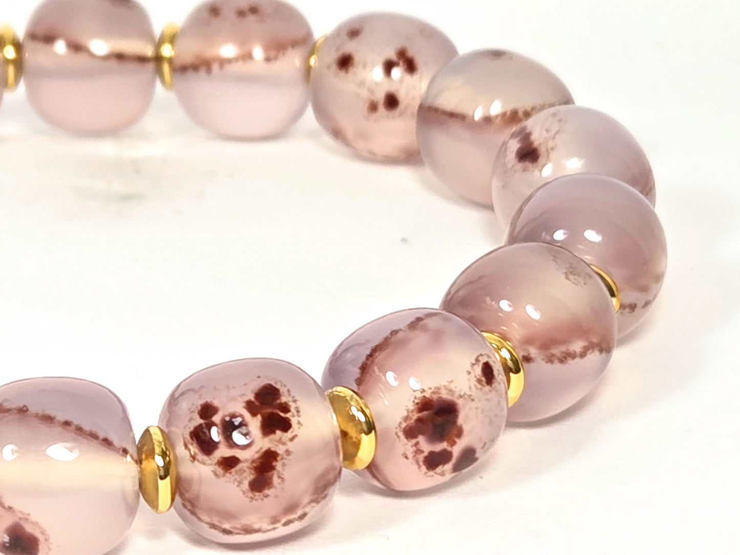 N-030526-CB2 macro, dense dark brown-red cinnabar cluster groupings in mauve-rose chalcedony, unretouched