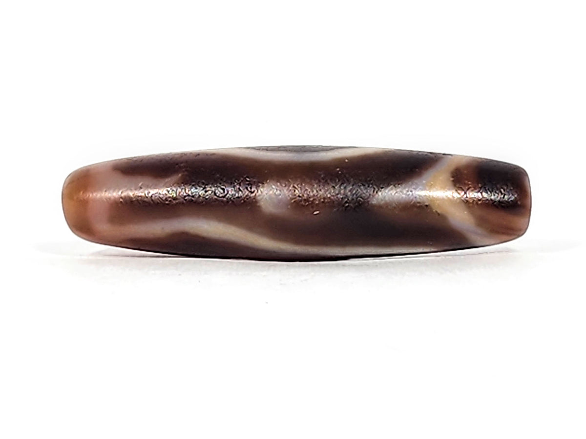 Antique eye-in-eye heaven gate dzi — bottom profile, reverse flat face, cream wave lines on warm brown ground, At-0426-EIE