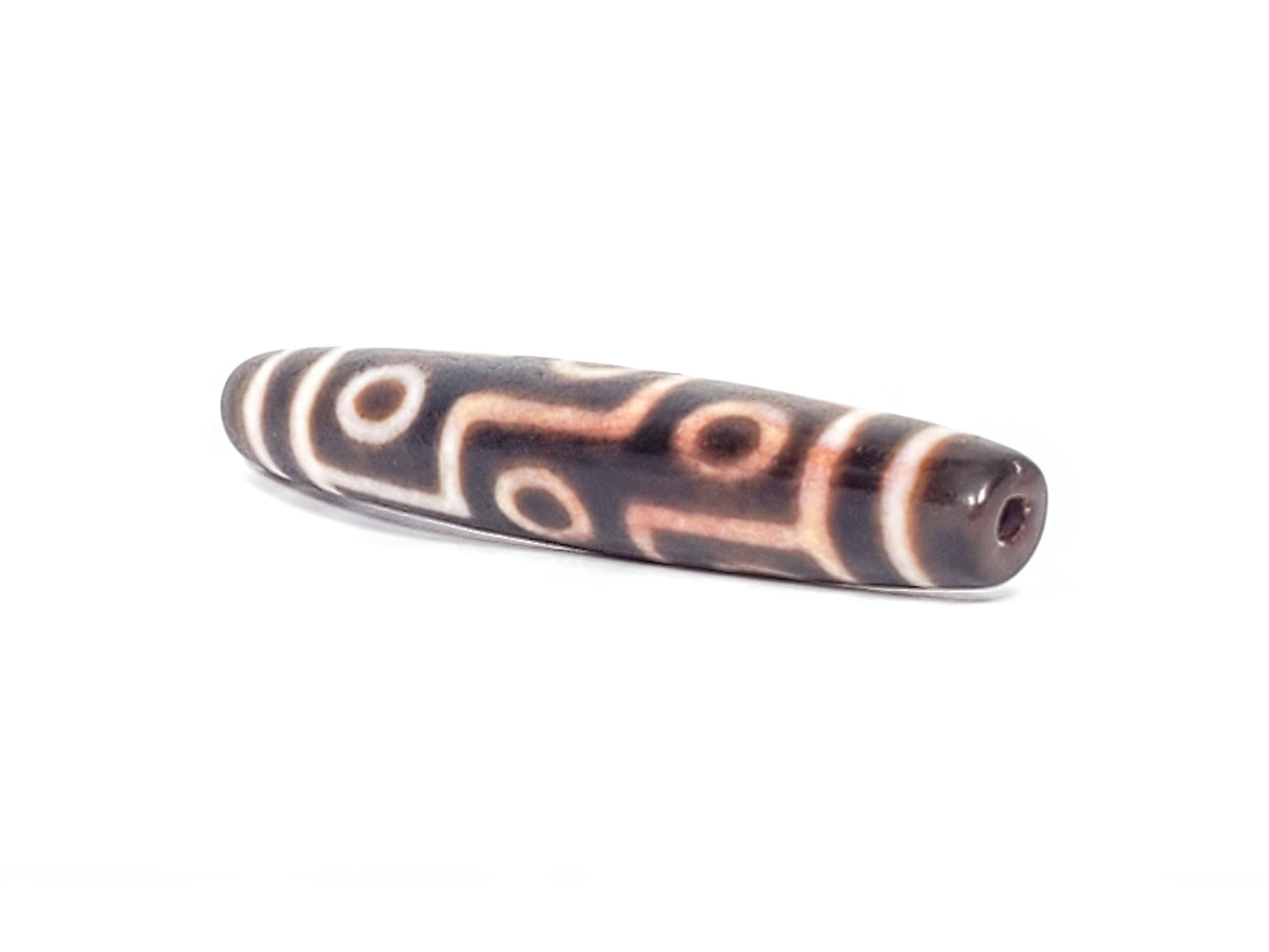 At-062926-9EBS angled drill-end view, spindle barrel form, nine eye motif, deep dark brown agate, unretouched