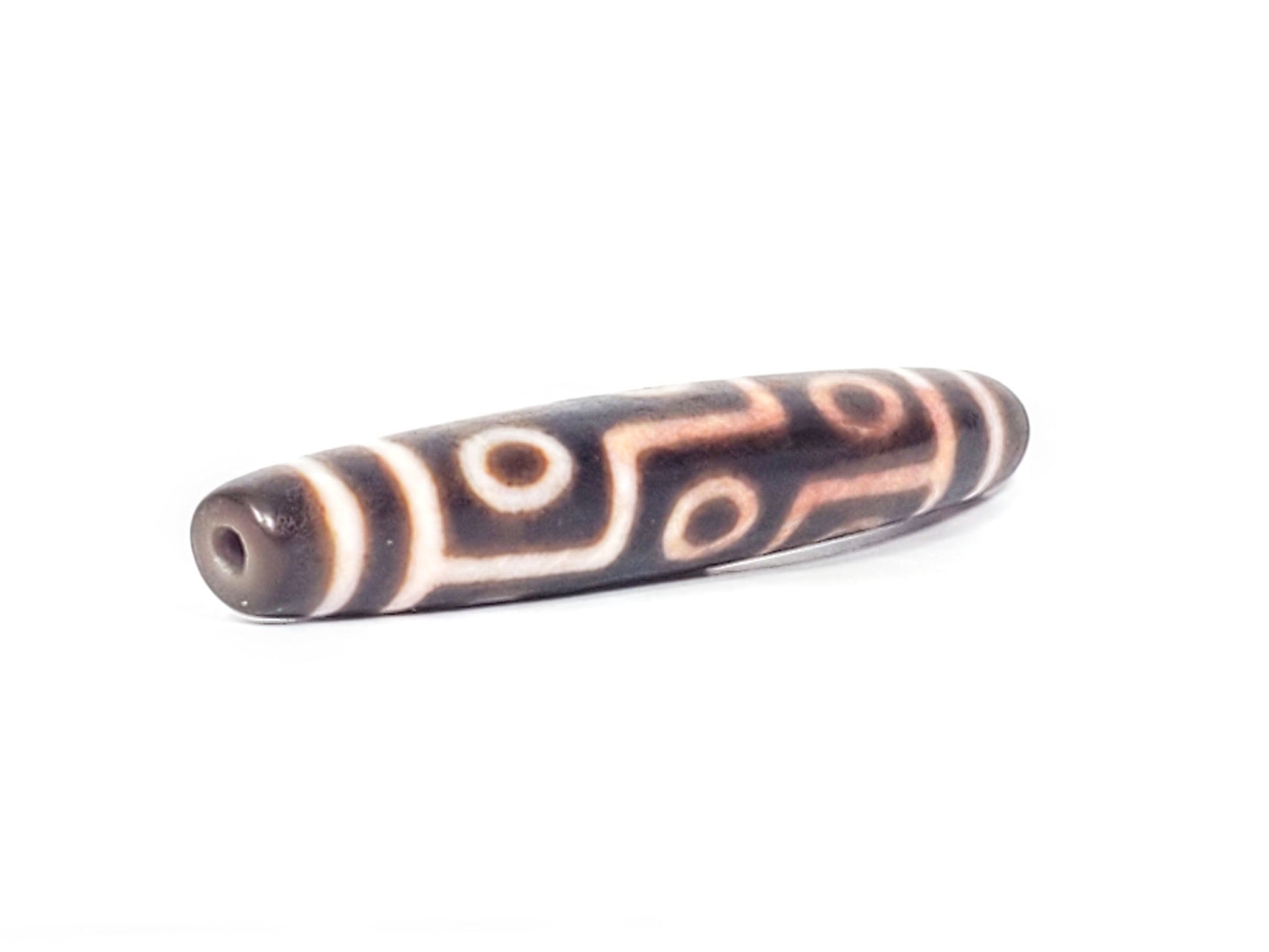 At-062926-9EBS angled view opposite end, 77.0mm nine eye dzi, drill hole visible, deep dark brown agate, unretouched