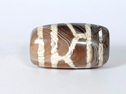 Antique longevity dzi — front face, raised white tortoise shell lattice on warm brown-grey banded agate, At-0426-Lon2