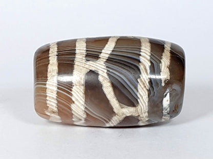 Antique longevity dzi — fourth face, grey-blue agate banding, raised white lattice on translucent ground, At-0426-Lon2