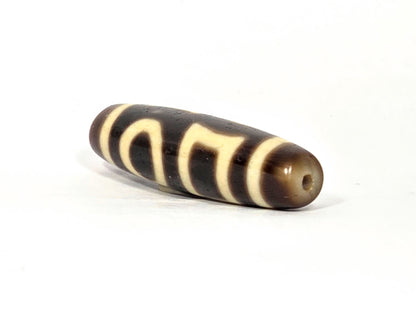 N-062926-DHE angled drill-end view, warm honey-brown end cap, standard drilling, very dark brown agate, unretouched