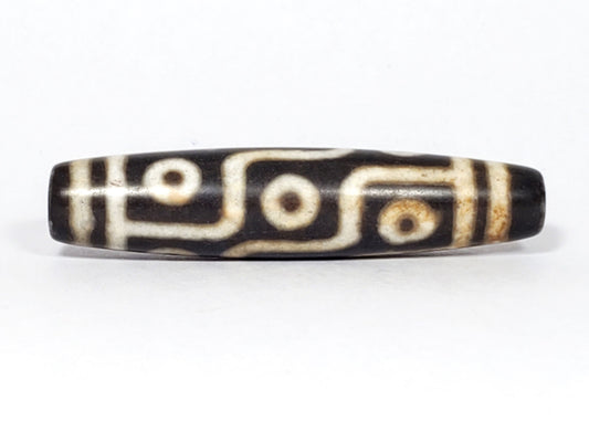 N-062226-9E2, nine eye agate dzi, 57.3×13.0mm, very dark warm brown, warm cream motif, face A, unretouched