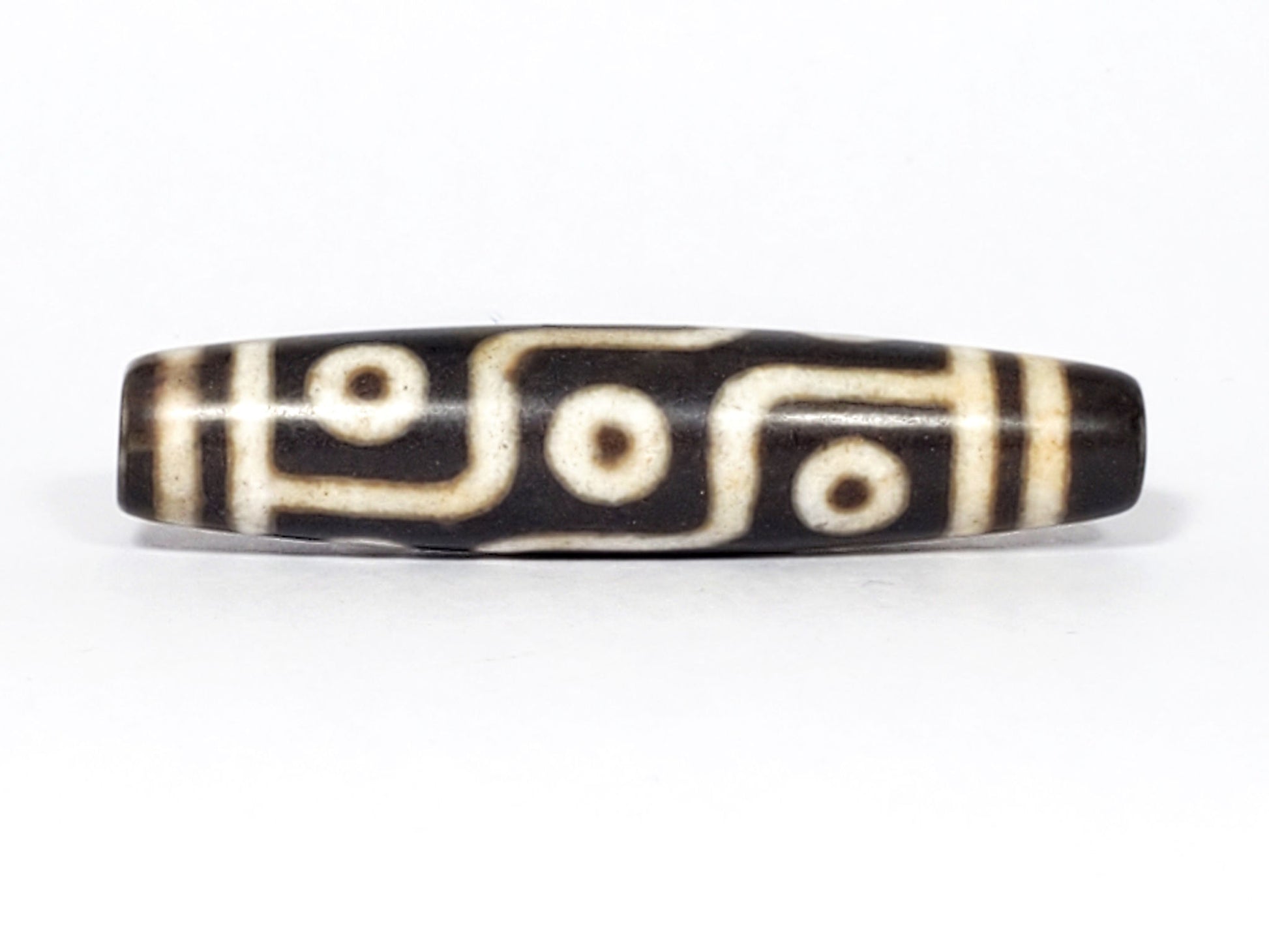 N-062226-9E2, face C, nine eye dzi, very deep dark warm brown, cream motif with honey-tan warmth, unretouched