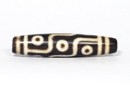 N-062226-9E2, face C, nine eye dzi, very deep dark warm brown, cream motif with honey-tan warmth, unretouched