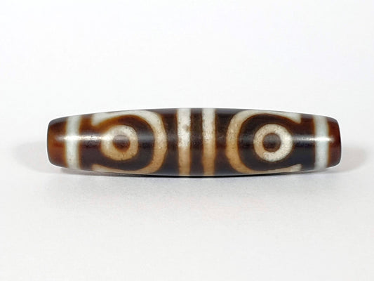 N-062426-4E new four eye dzi 58.5x13.9mm Face A open C-ring and closed ring eyes medium-dark warm brown agate unretouched