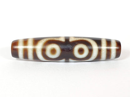 N-062426-4E new four eye dzi 58.5x13.9mm Face B two closed-ring eyes connected at centre warm brown agate unretouched
