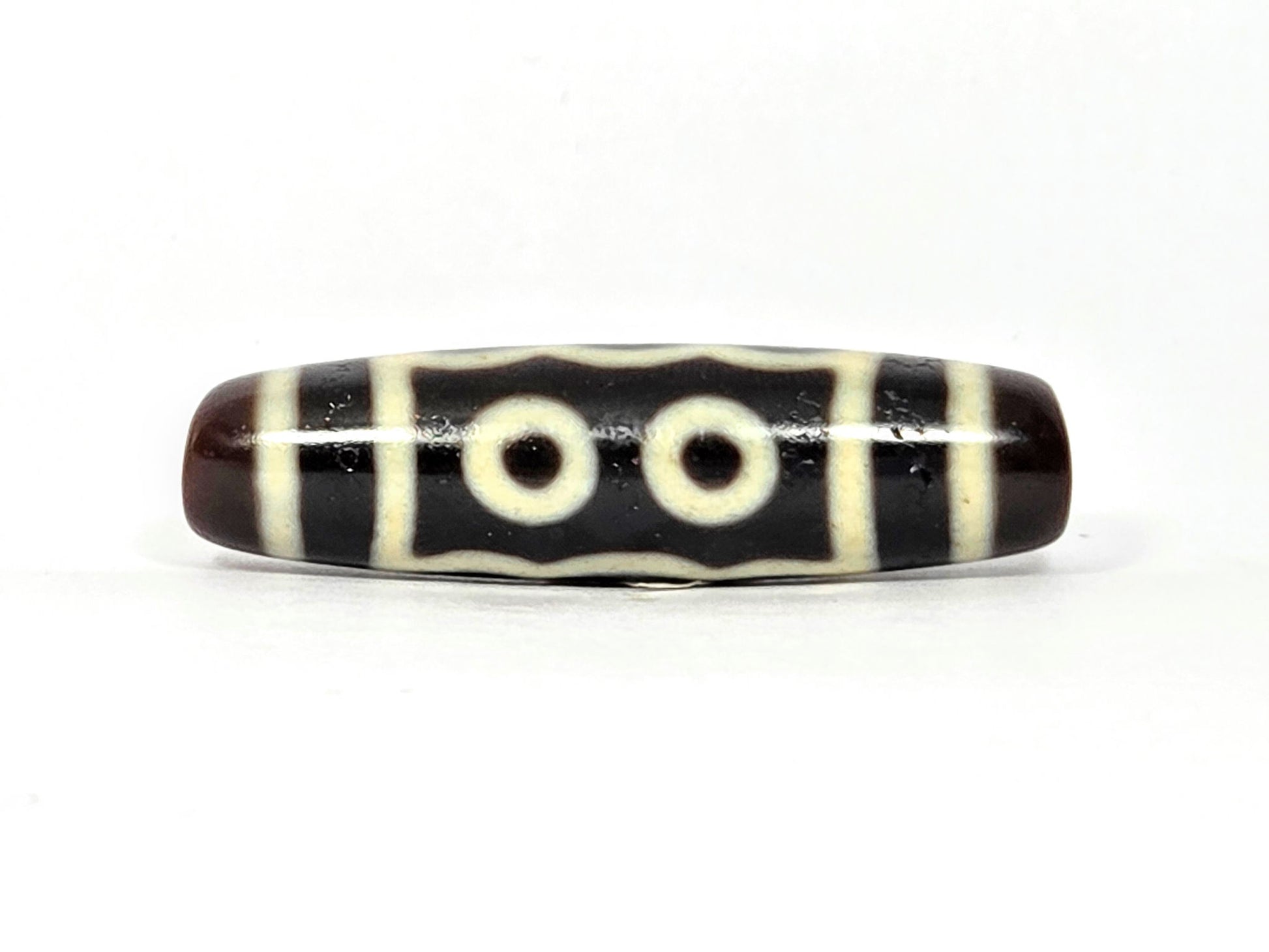 N-091125-5E2 two-eye face, two cream-white eye rings, very dark brown agate dzi, unretouched