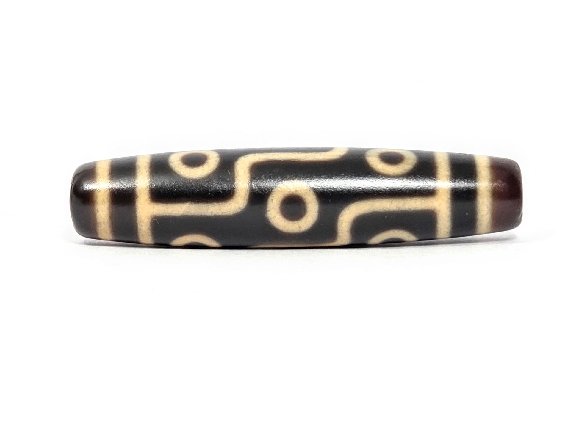 N-122225-9E Nine Eye dzi bead, front view, deep dark brown agate, 57.9×13.0mm, unretouched