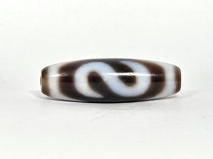 N-070526-MHkBS rotated face 3, money hook dzi, very dark brown ground, S-curve hook form, cream lines, unretouched