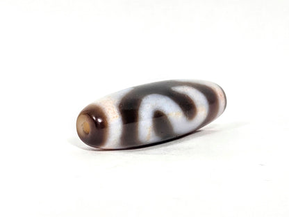 N-070526-MHkBS opposite drill-end angled, money hook dzi, warm brown end cap, dark brown body, unretouched