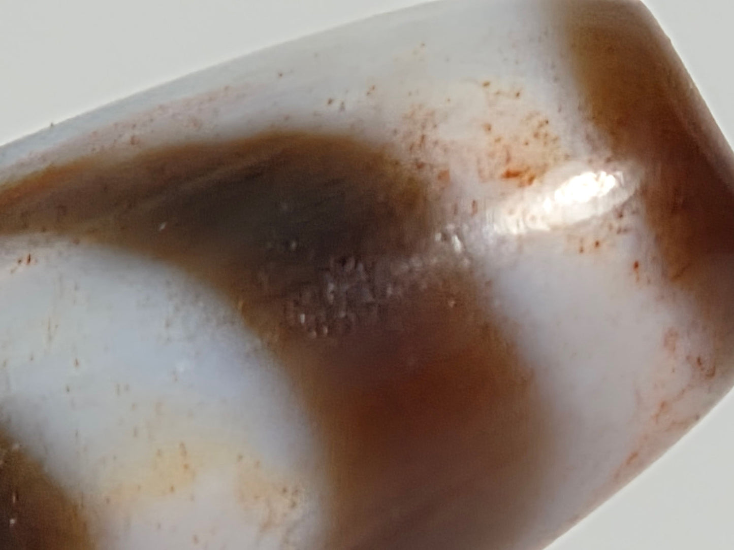 N-070526-MHkBS macro end-cap shoulder, reddish-brown cinnabar inclusions, cream zone boundary, unretouched
