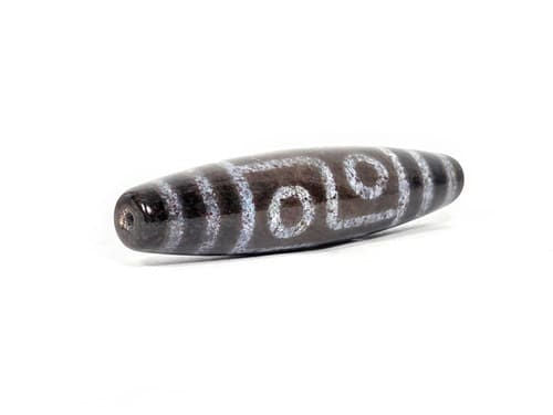 N-062126-6E dzi bead, three-quarter angle showing drilled end, unretouched