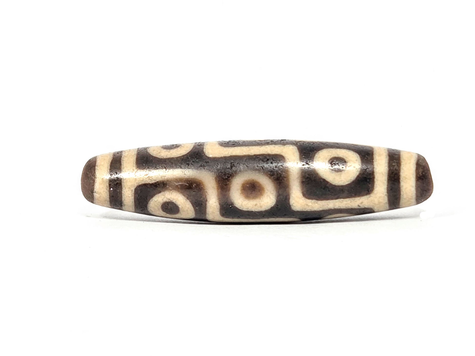 Ac-032326-9E5 Face A rotated, nine-eye meander composition showing different eye positions, warm brown agate, unretouche