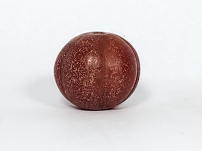 Ac-061126-PKP Bead A front, deep reddish-brown carnelian, dense crackle texture on lobe valleys, ribbed form, unretouched