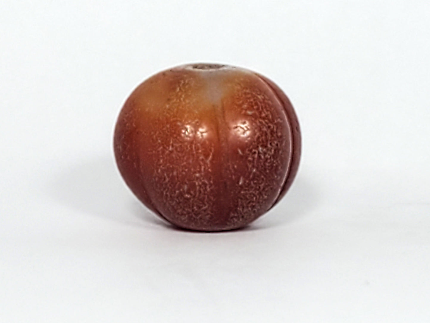Ac-061126-PKP Bead B front, honey-brown carnelian with natural agate banding, ribbed pumpkin form, unretouched