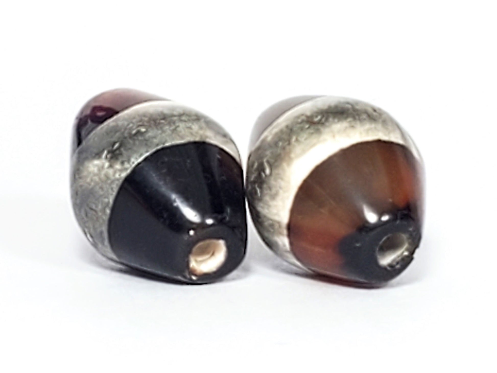 At-081123-1SPair drill hole ends, Bead A pitch-black cone, Bead B warm brown banded cone, grey-white stripe, unretouched