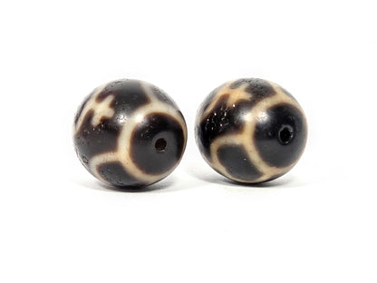 Side profile view of matched pair of round Treasure Vase dzi beads showing spherical shape and agate quality