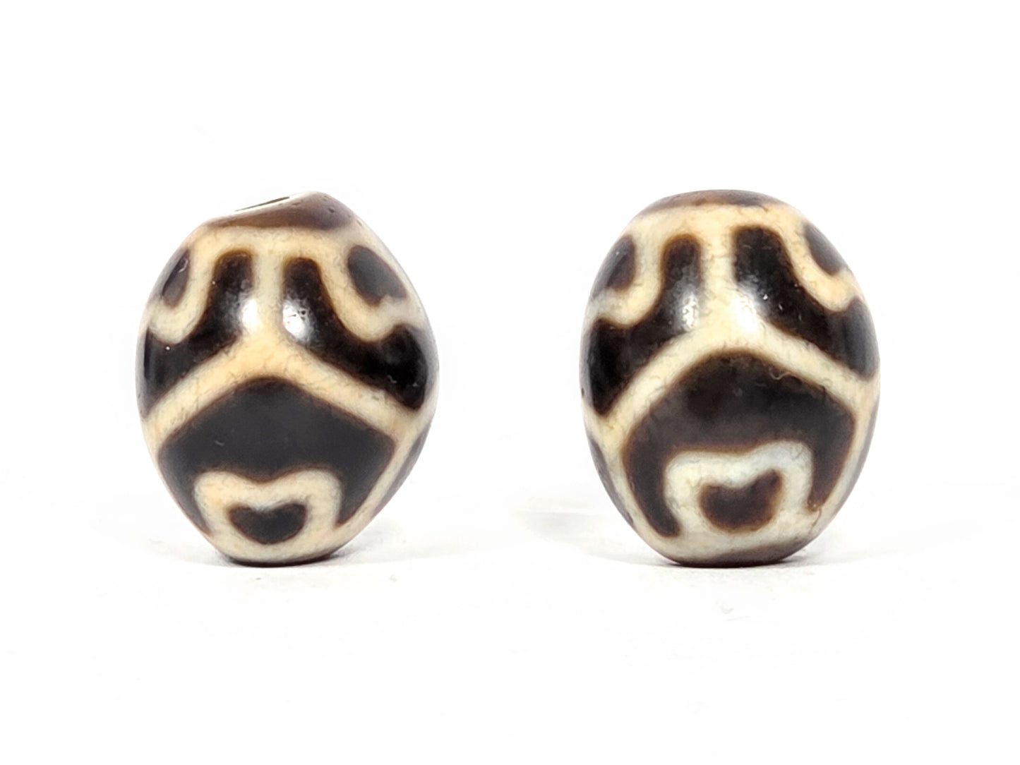 pair of dzi beads suitable for placement on bracelet