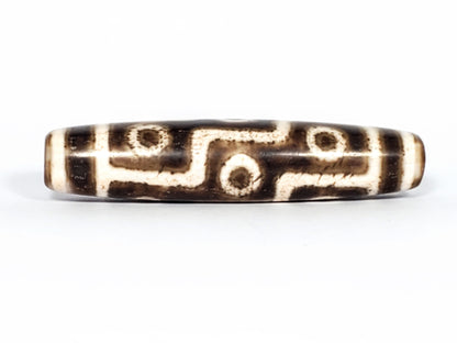 Qing Dynasty nine eye dzi — Face A, nine eye motif with S-curve connectors, dark ground, granular cream zones, At-0426-9EQ
