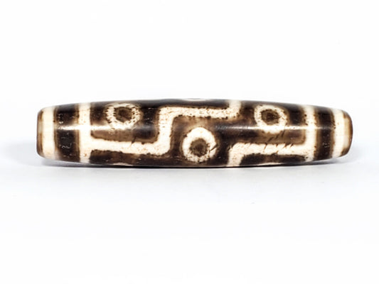 Qing Dynasty nine eye dzi — Face A, nine eye motif with S-curve connectors, dark ground, granular cream zones, At-0426-9EQ