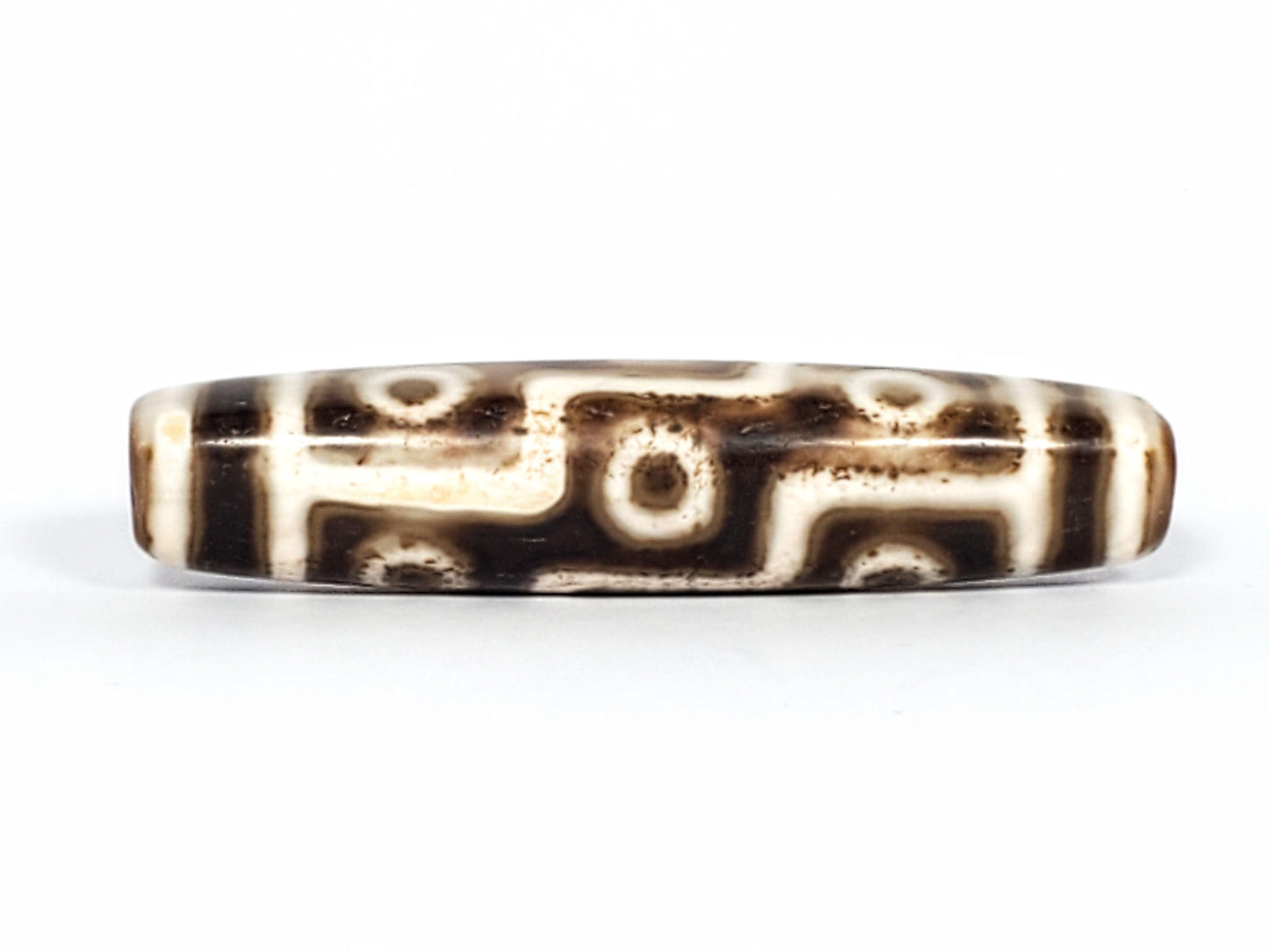 Qing Dynasty nine eye dzi — third face, eyes and S-curve motif, near-black ground, ridge line visible, At-0426-9EQ