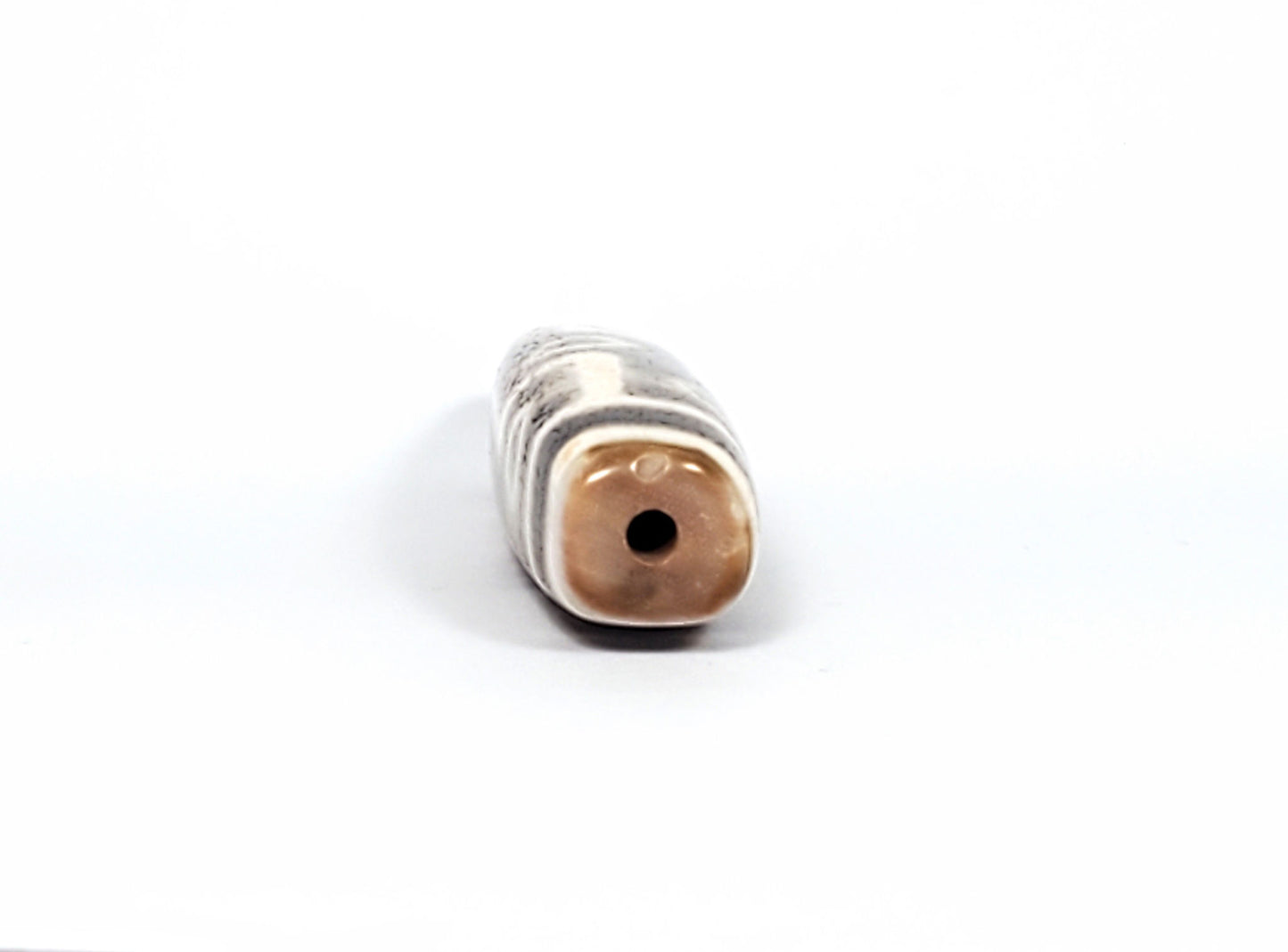 Qing Dynasty nine eye dzi — opposite end-on, squared cross-section, warm brown cap, centred drill hole, At-0426-9EQ