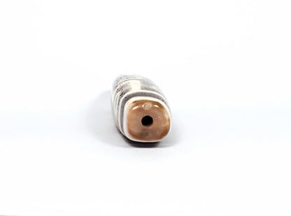 Qing Dynasty nine eye dzi — opposite end-on, squared cross-section, warm brown cap, centred drill hole, At-0426-9EQ