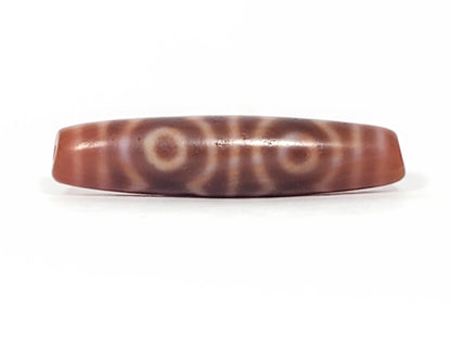 At-082624-6EBS, antique six eye dzi, 54.5×13.2mm, warm rose-brown agate, low-contrast closed eyes, unretouched