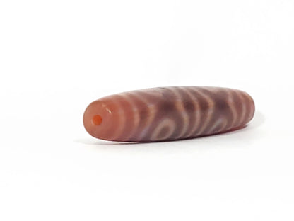 At-082624-6EBS, opposite end angled view, six concentric eyes wrapping full body, matte rose-brown agate, unretouched