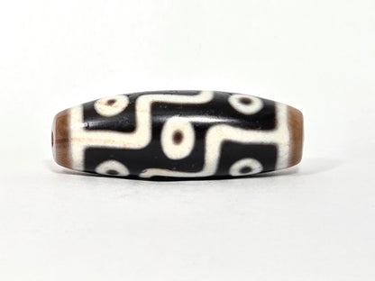 At-061926-9E6BS Face B, 5 closed ring eyes, sandy-tan end caps, pitch-black ground, cream-white motif, unretouched
