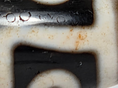 At-061926-9E6BS macro, dark red cinnabar halo inclusions in pitch-black ground zone, unretouched
