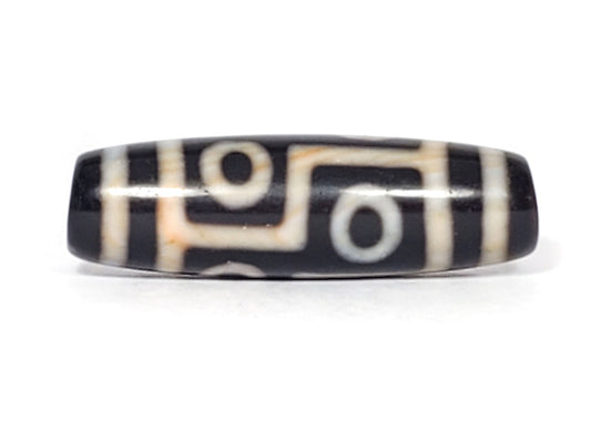 N-051423-6E dzi bead, angled view showing eye and stepped-line motif, black agate, unretouched photo.