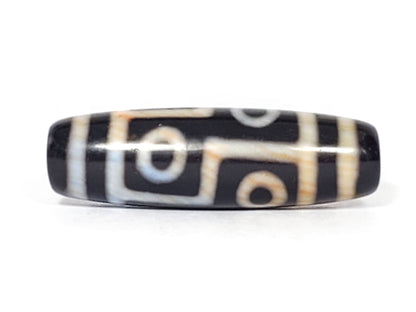 Six eye dzi bead, black agate with cream and tan striped patterns, polished surface, 38.2mm