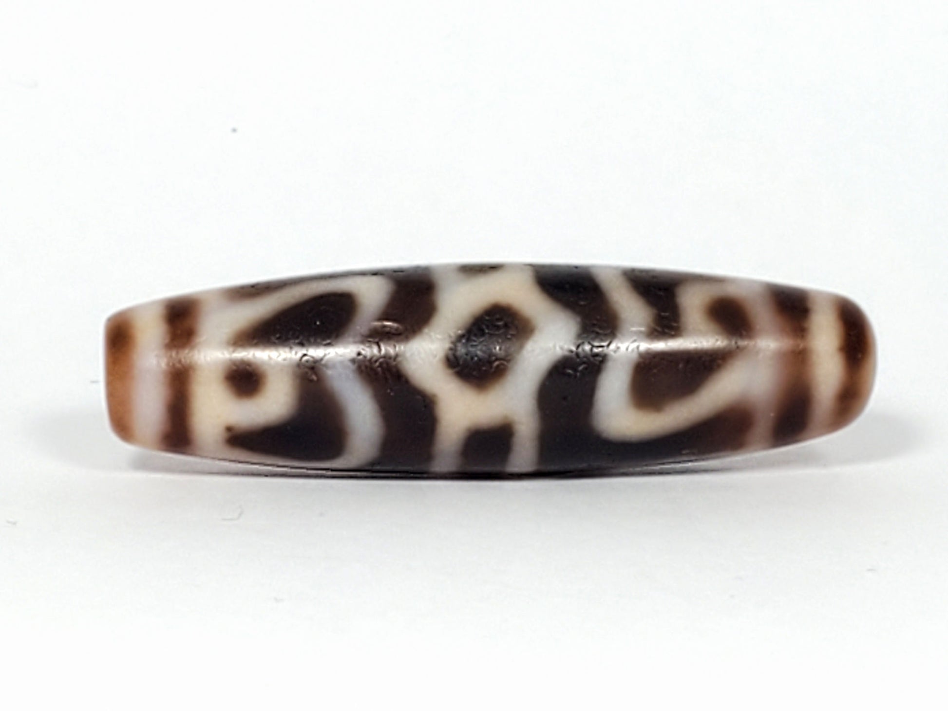 Ac-061926-GRDC Face C, cap peak arch and bracket forms, warm chocolate-brown, age micro-texture, unretouched