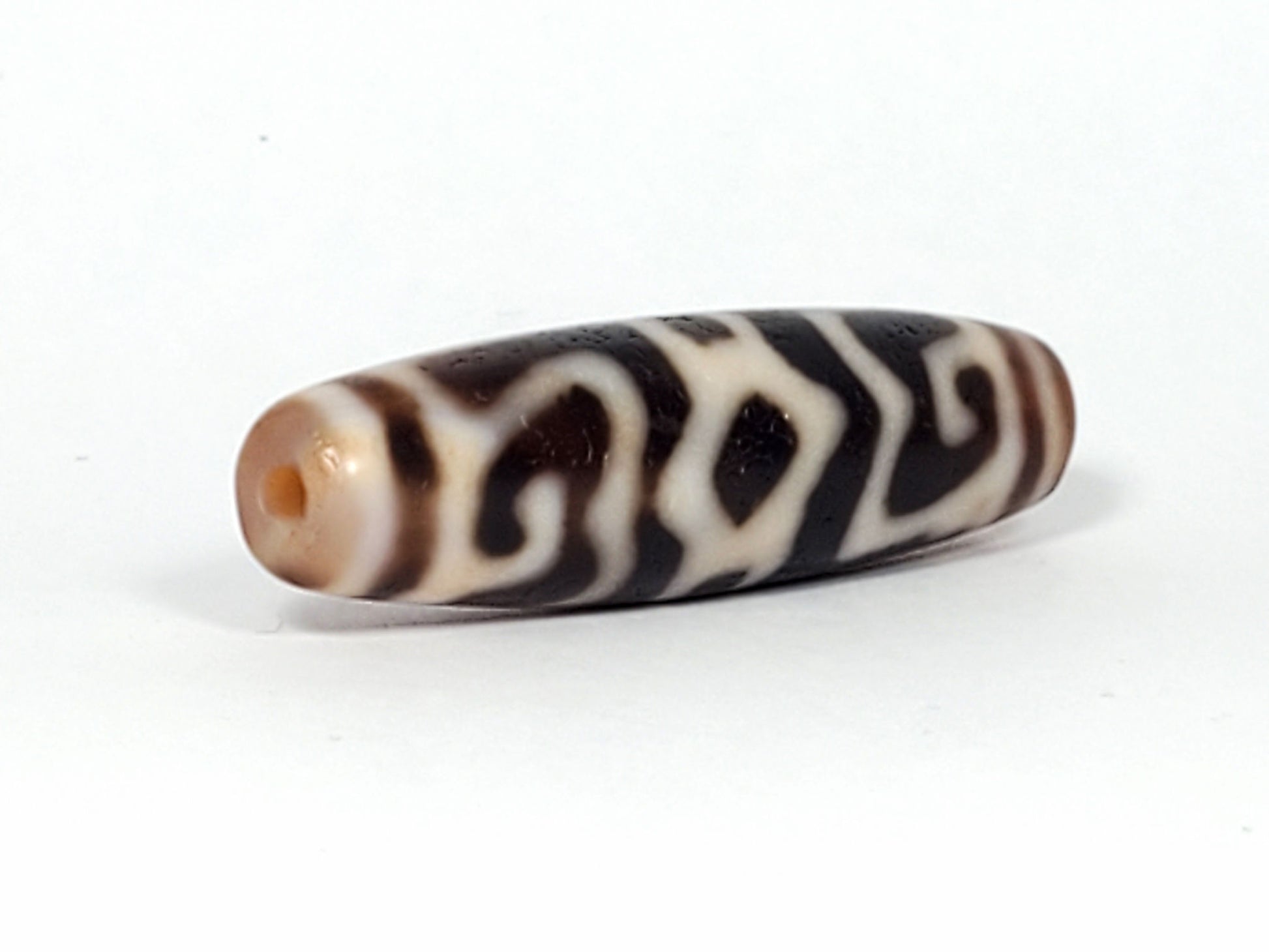 Ac-061926-GRDC angled tip A, elongated fusiform form, honey-brown cap, small drill hole, unretouched