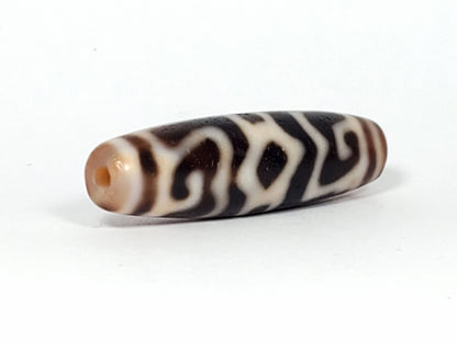 Ac-061926-GRDC angled tip A, elongated fusiform form, honey-brown cap, small drill hole, unretouched