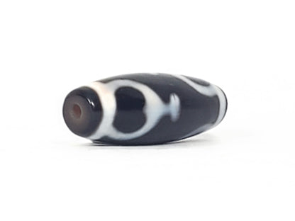V-092224-TrVBS dzi bead, diagonal view showing drill hole and warm brown channel, unretouched.