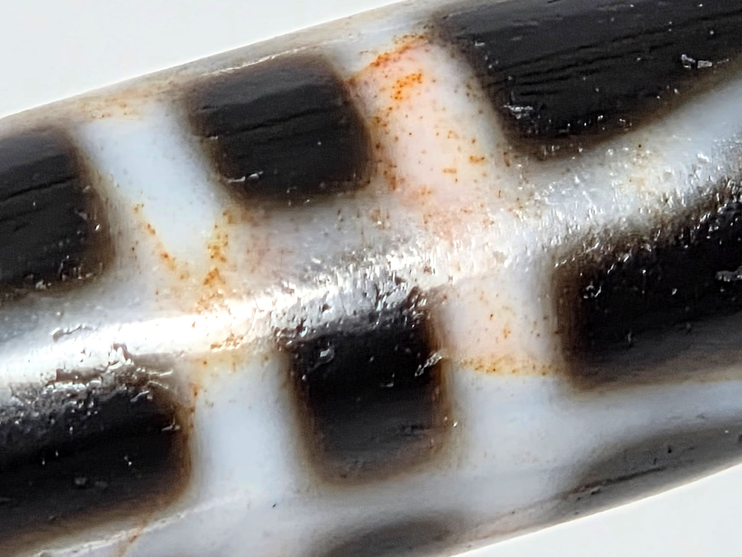 V-070526-3VjBS macro opposite face, warm brick-red cinnabar bloodspots, cream zone boundary, unretouched