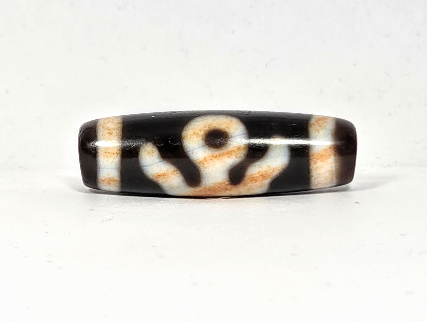 Vintage Benefactor motif dzi bead V-021326-BenBS, 36.8×11.6mm, front face, pitch-black & dark brown agate, unretouched.