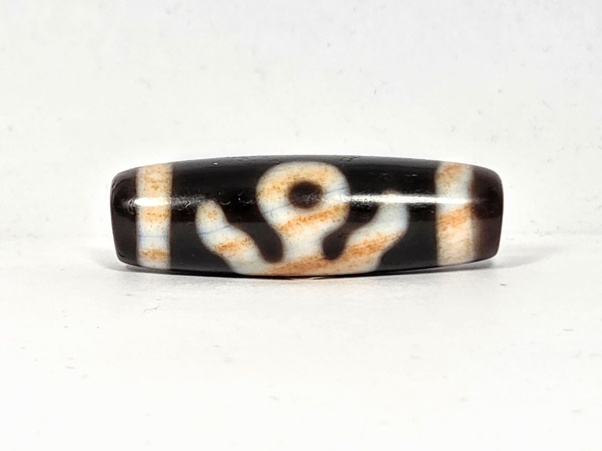 Vintage Benefactor motif dzi bead V-021326-BenBS, 36.8×11.6mm, front face, pitch-black & dark brown agate, unretouched.