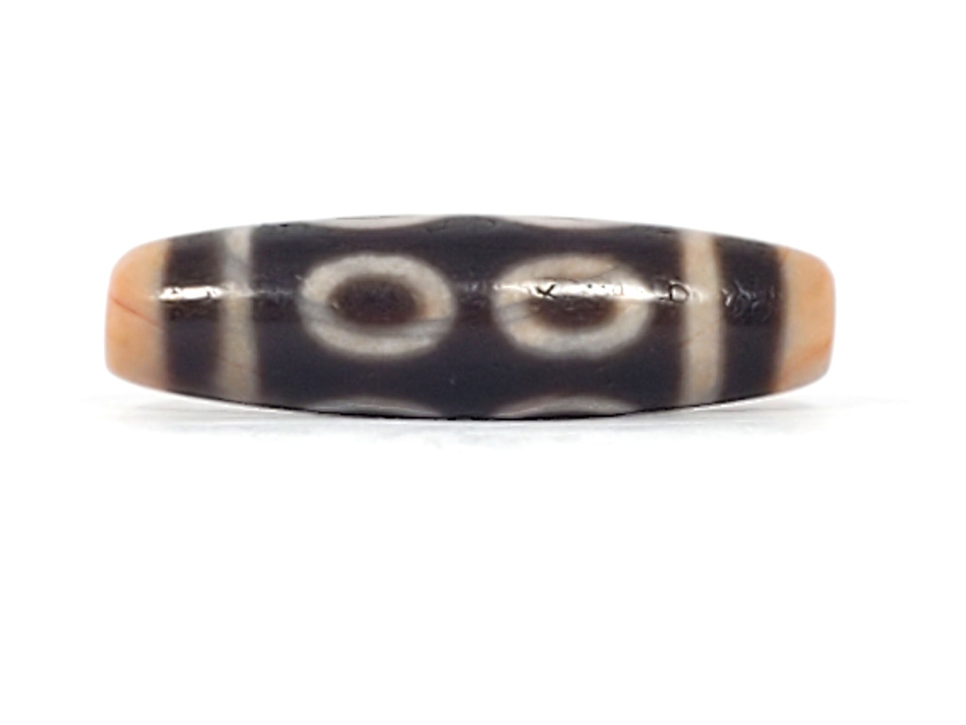 V-092924-8EBS Eight Eye dzi bead, alternate front angle, peachy-apricot end caps and deep dark brown body, unretouched