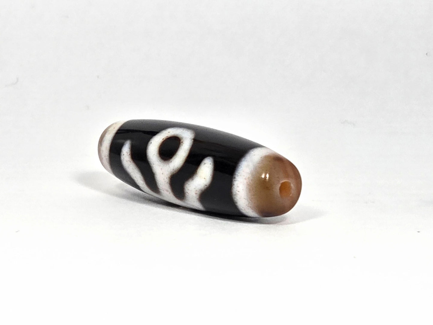 V-090126-BENBS vintage benefactor dzi drill end view one warm honey-brown cap pitch-black unretouched