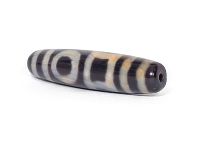 V-092723-DHE Double Heaven & Earth dzi bead, angled end view showing drill hole, pitch-black body and natural banding, unretouched