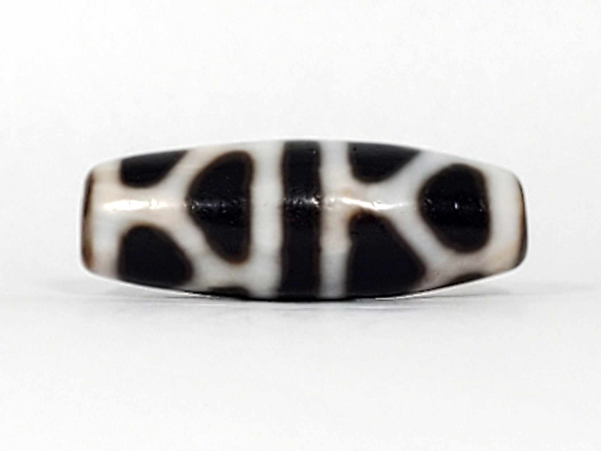 V-092824-DLBS Double Longevity dzi bead, front face, cream-white dominant agate, 34.9×12.6mm, dark zones floating in cream field, unretouched