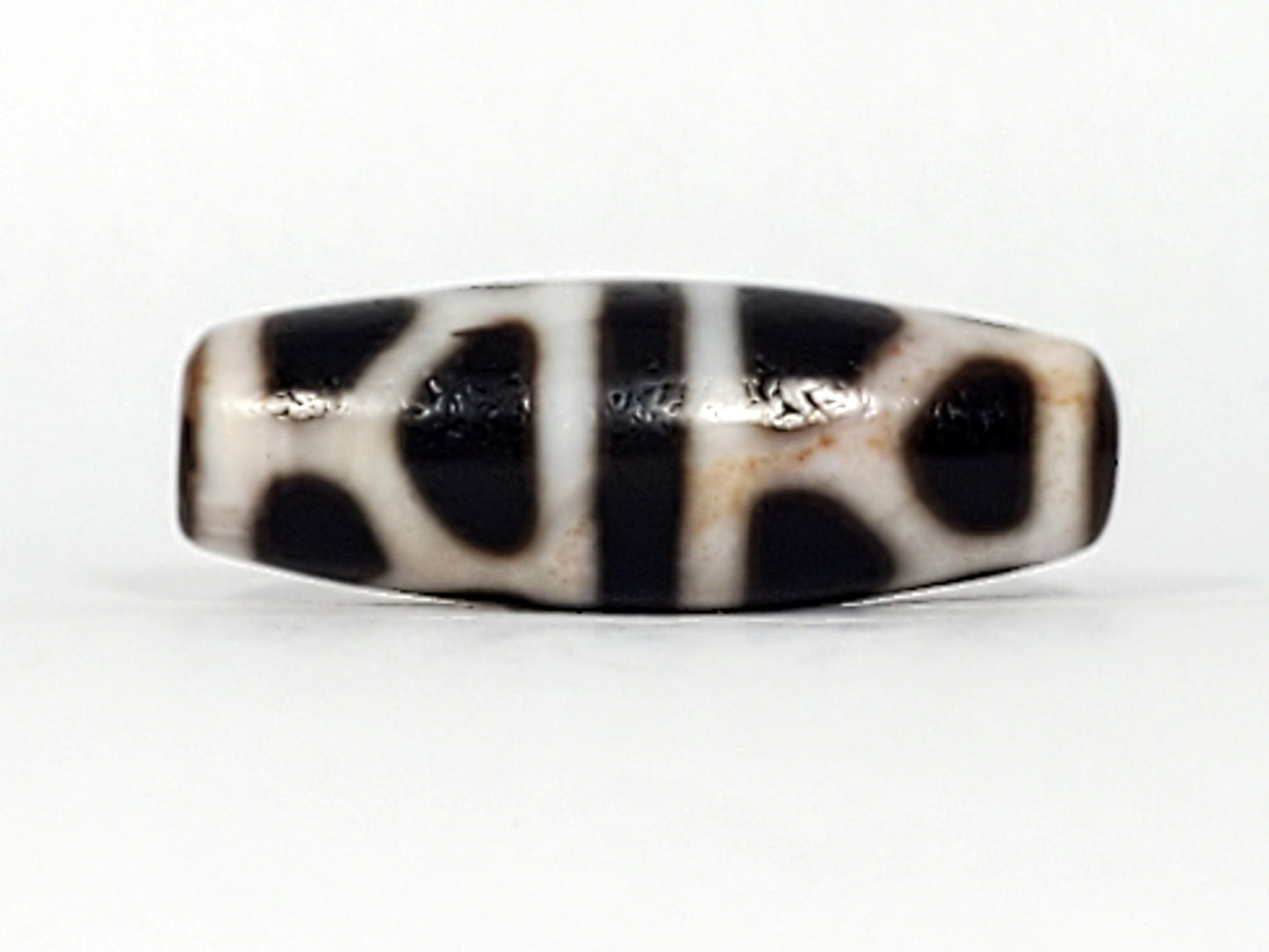 V-092824-DLBS Double Longevity dzi bead, alternate face, cream-white field with pitch-black enclosed shapes, unretouched