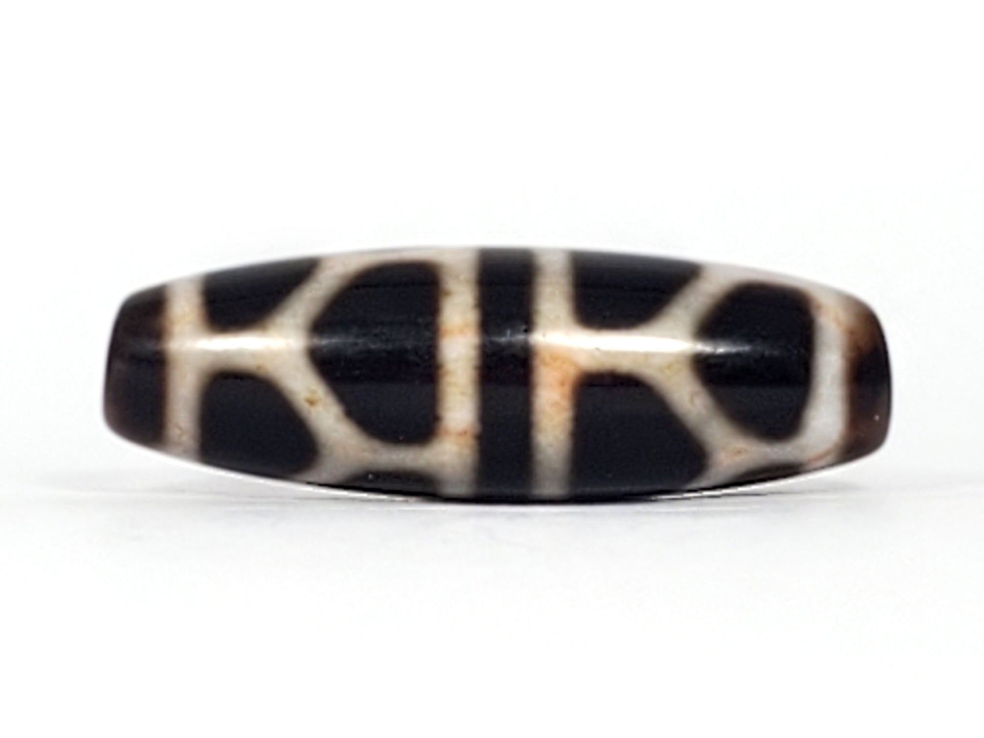 V-092824-DLBS2 Double Longevity dzi bead, alternate face, broad cream grid on pitch-black ground, honey-rust boundary zones, unretouched