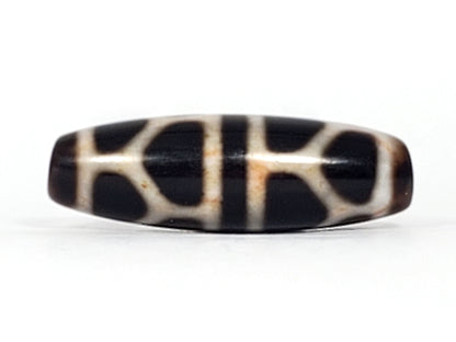 V-092824-DLBS2 Double Longevity dzi bead, alternate face, broad cream grid on pitch-black ground, honey-rust boundary zones, unretouched